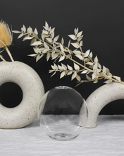 Load image into Gallery viewer, Neva, which is the Latin word for snow, is the perfect name for this snow globe inspired design. With its curved and sculpted silhouette it provides a cozy embrace for your Everlasting Candles and evokes the sense of gathering loved ones together. Product Highlights Custom design Handblown glass Statement piece